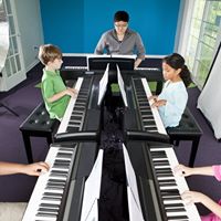 students playing pianos